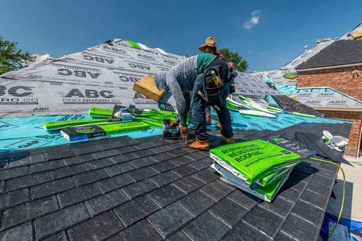 Roofing crew installing underlayment on a stripped deck in Joliet, IL